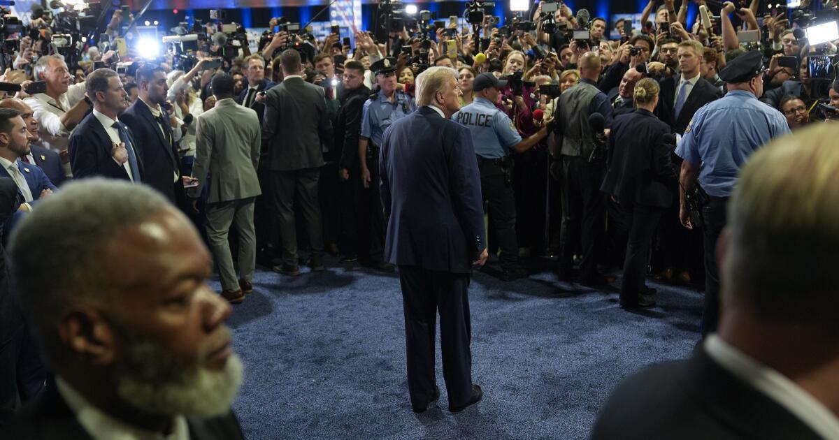 Republican presidential nominee former President Donald Trump, center, speaks to reporters in the spin room after a presidential debate with Democratic presidential nominee Vice President Kamala Harris, Tuesday, Sept. 10, 2024, in Philadelphia. (AP Photo/Pablo Martinez Monsivais)