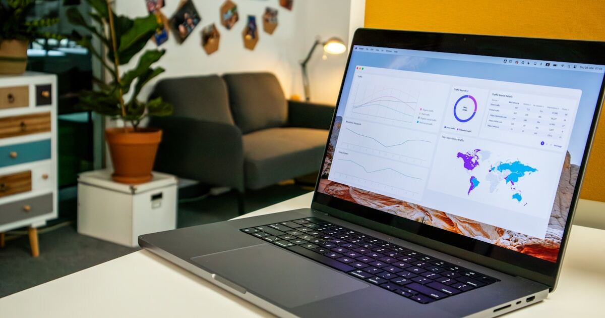 a laptop computer sitting on top of a white table