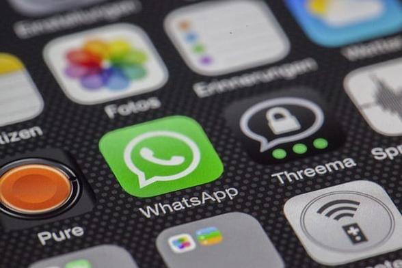 WhatsApp logo on a phone.