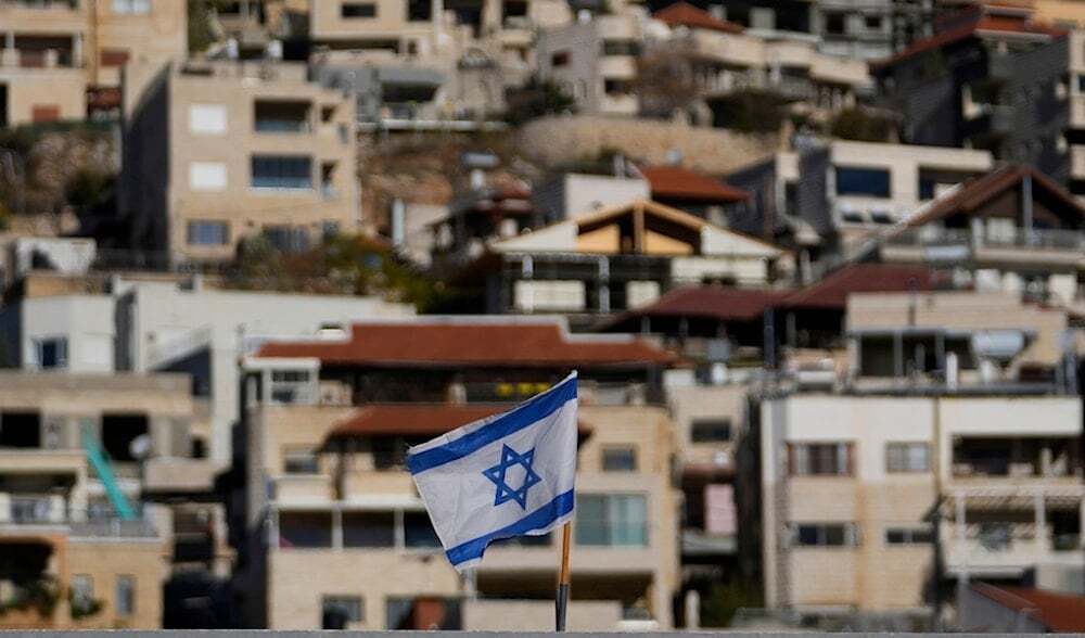 An Israeli flag flies on a roof in the town of Majdal Shams, near the so-called Alpha Line that separates the Israeli-occupied Golan Heights from Syria, Sunday, Dec. 15, 2024. (AP)
