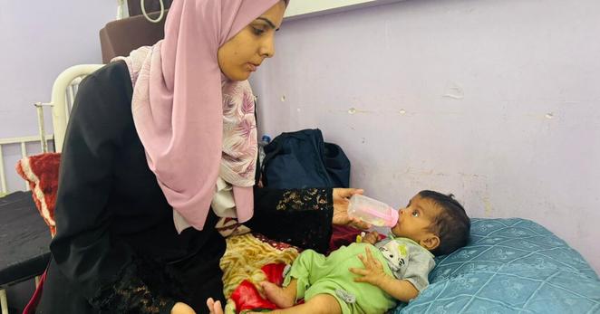 Hanin Barghouth with her 3-month-old daughter, Salam, at Al-Aqsa Martyrs Hospital in central Gaza this week. At birth, her doctor said, Salam weighed roughly 6.6 pounds, and three months later, she weighs only 8.8 pounds — at least three pounds underweight.