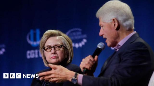 A file photo of Bill and Hillary Clinton on stage at an event - Bill is speaking into the microphone A file photo of Bill and Hillary Clinton on stage at an event - Bill is speaking into the microphone