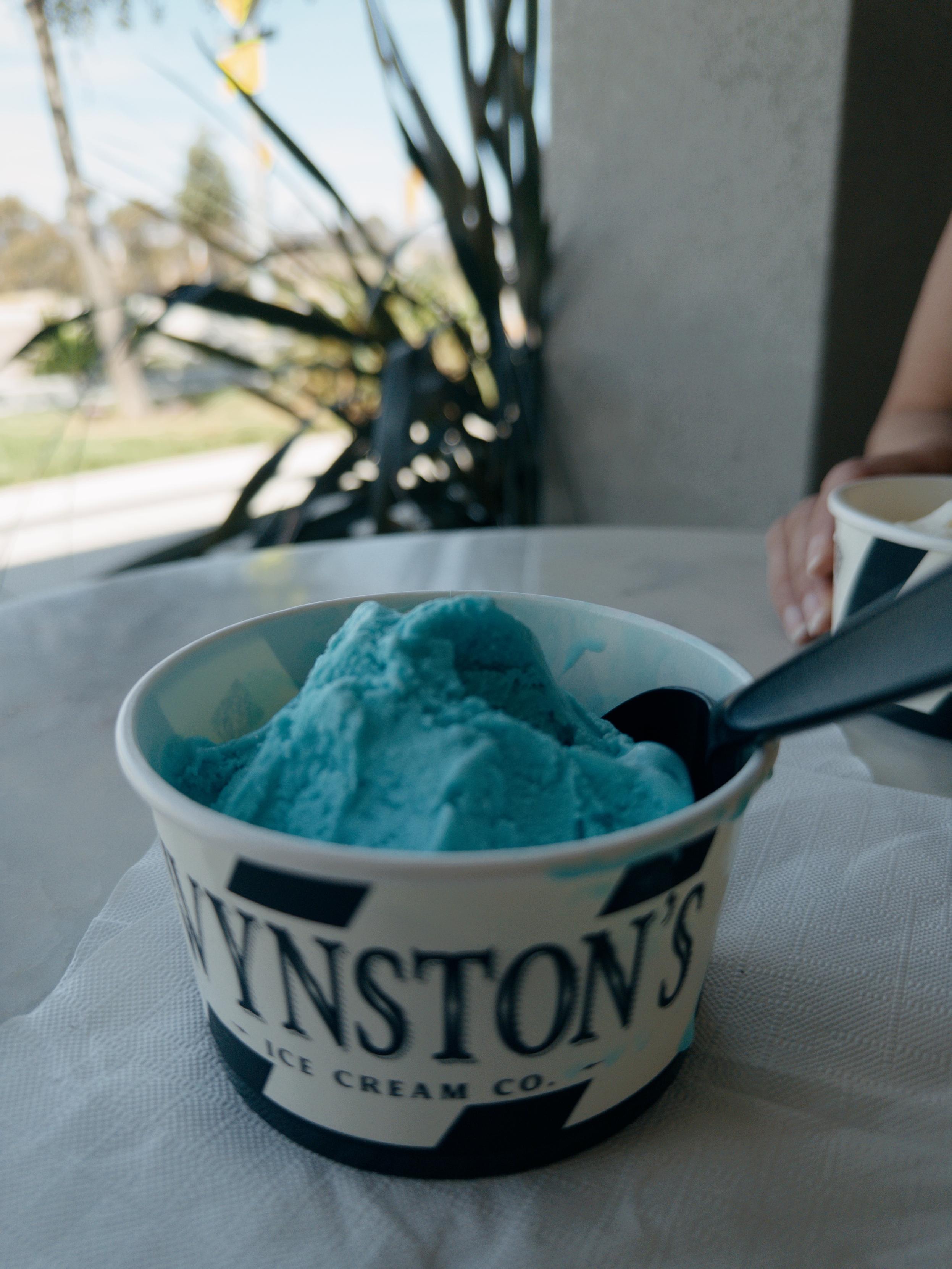 A cup of Blue Moon ice cream in a container that says “Winston’s ice cream co.”