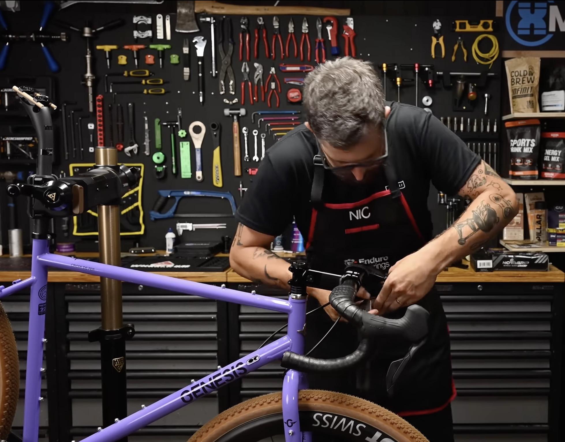 Vic wrapping the handlebars. Tools behind him all laid out just right, every one has a specific spot and is returned there once it has served its purpose on the build.
